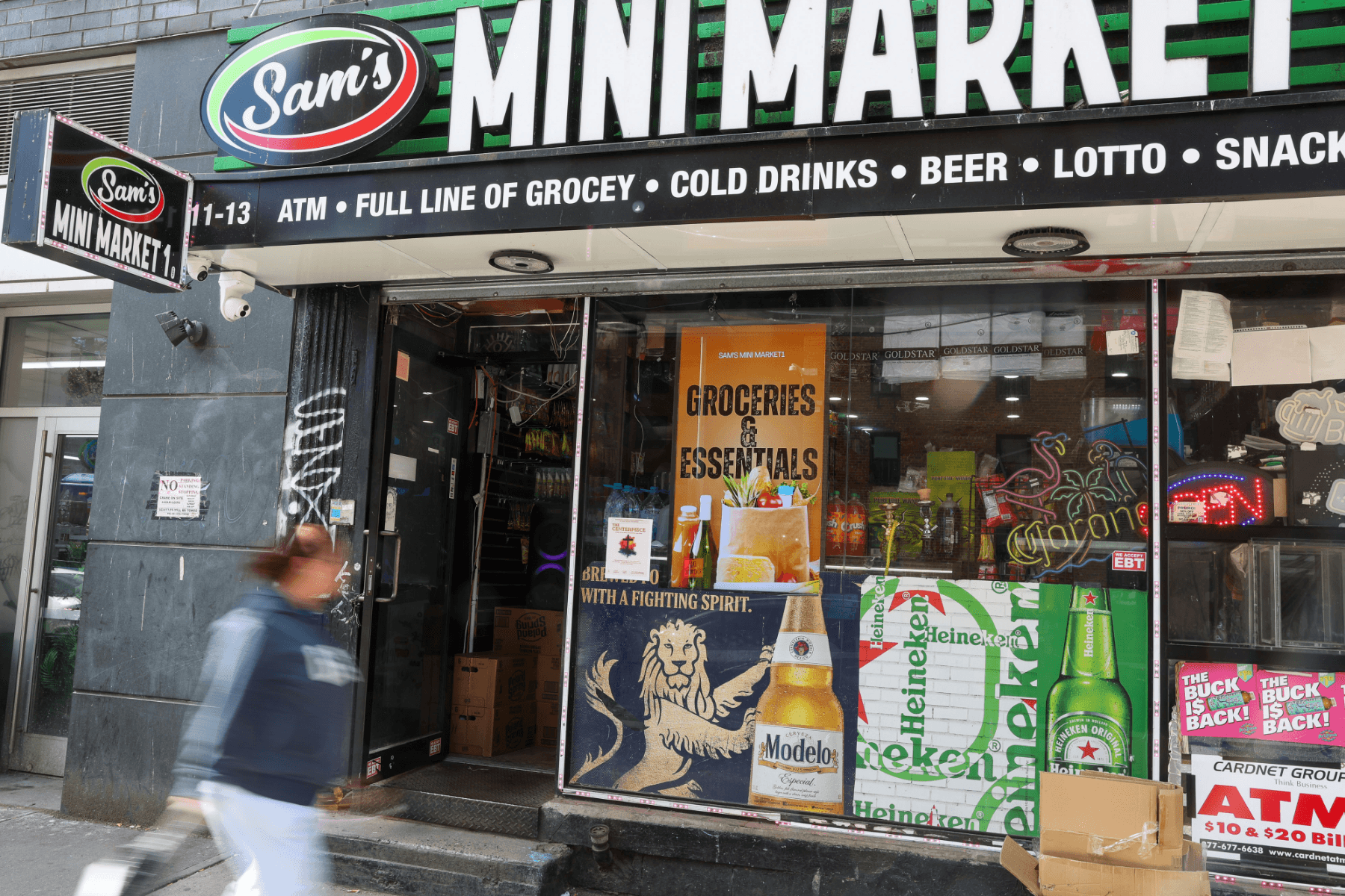 Sam's Mini Market storefront with a PrimeSight LED screen